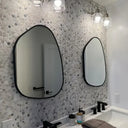 Mirror framed with a satin black metal circle