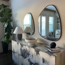 Mirror framed with a satin black metal circle